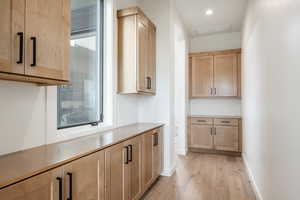 Kitchen featuring light brown cabinets and light wood-type flooring