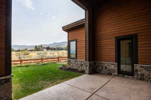 View of patio / terrace featuring a mountain view and a rural view