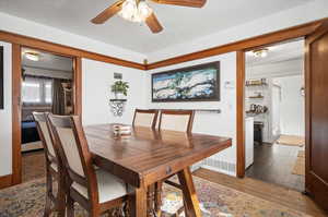 Dining space featuring ceiling fan and hardwood floors