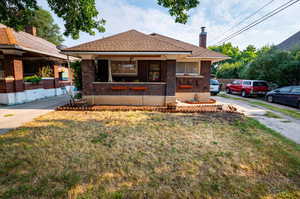 View of front facade with covered porch and a front yard