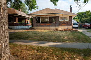 View of front of property with a porch and front yard