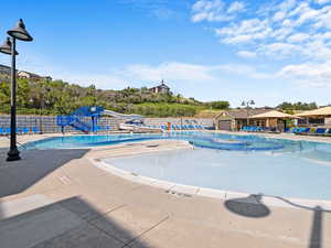 View of pool featuring a water slide and a patio area