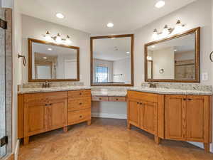 Luxurious Bathroom with dual  vanities and Travertine flooring