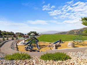 Exterior space featuring a lawn and a mountain view