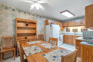 Dining room featuring light tile patterned flooring and ceiling fan