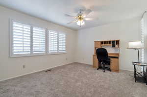 Unfurnished bedroom featuring new carpet and ceiling fan