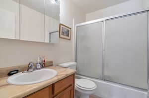 Full bathroom with vanity and shower / bath combination with glass door