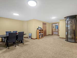 Dining area featuring light carpet and baseboards