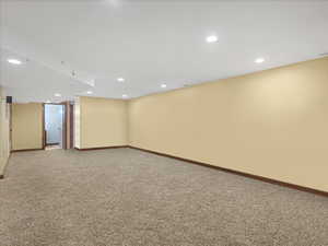 Finished basement with recessed lighting and carpet floors