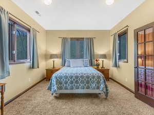 Carpeted bedroom featuring baseboards