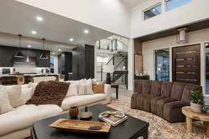 Tiled living room with a towering ceiling