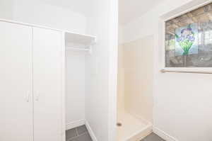 Bathroom featuring tile patterned flooring and a shower