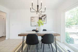 Dining space featuring a notable chandelier and light hardwood / wood-style floors