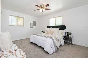 Carpeted bedroom with ceiling fan