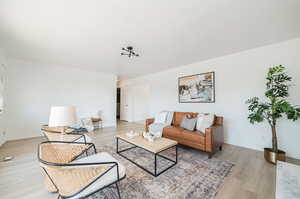 Living room with light wood-type flooring