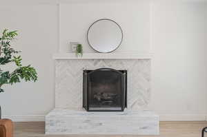 Room details featuring hardwood / wood-style floors and a brick fireplace