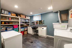 Laundry area featuring separate washer and dryer and cabinets