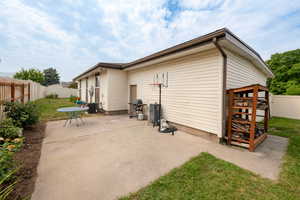 View of patio with cooling unit and a grill