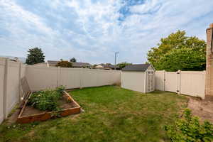 View of yard featuring a storage unit