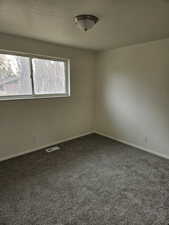 Empty room featuring carpet floors