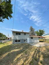 Rear view of property with a carport