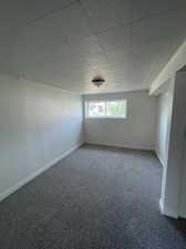 Carpeted empty room with a paneled ceiling