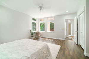 Bedroom featuring ceiling fan and dark wood-type flooring