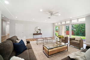 Living room featuring light wood-type flooring and ceiling fan