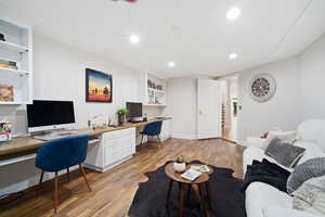 Office featuring built in desk and light hardwood / wood-style floors