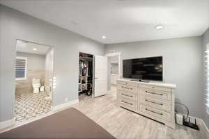 Tiled bedroom featuring a closet and connected bathroom