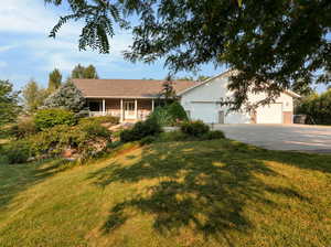 Ranch-style house with a front lawn and a garage