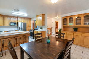 Tiled dining space with a textured ceiling