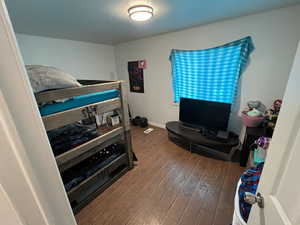 Bedroom with wood-type flooring