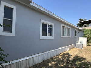 View of side of property with central air condition unit