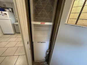 Interior details featuring tile patterned floors and white fridge