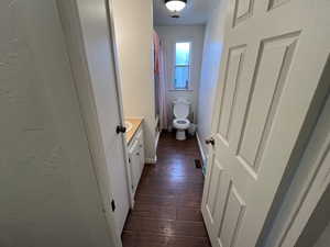 Bathroom with vanity, toilet, and hardwood / wood-style floors