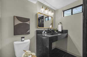 Bathroom with sink, tile patterned floors, and toilet