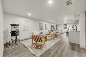 Living room with light hardwood / wood-style flooring