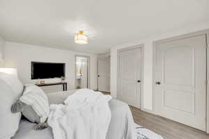 Bedroom featuring ensuite bath and light hardwood / wood-style flooring