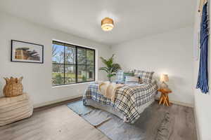 Bedroom with light hardwood / wood-style floors