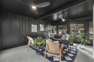 Sunroom / solarium featuring beam ceiling and ceiling fan