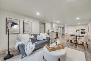 Living room with light hardwood / wood-style flooring