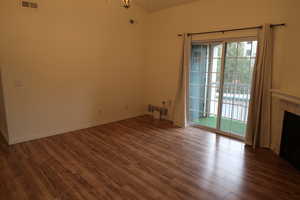 Unfurnished living room featuring dark hardwood / wood-style floors and a fireplace