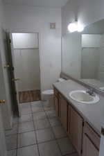 Bathroom with tile patterned floors, vanity, and toilet