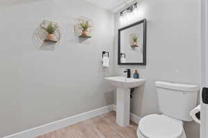 Bathroom featuring wood-type flooring and toilet