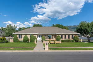 Single story home featuring a mountain view and a front yard