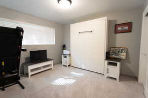 Interior space with a textured ceiling and light carpet