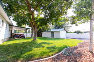 View of yard with a storage unit