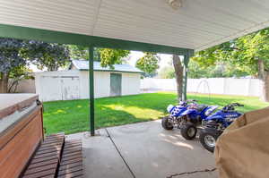 View of patio featuring a storage unit