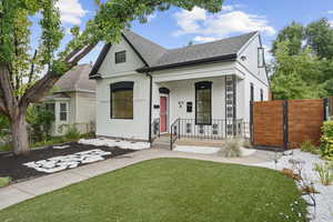 View of front of property featuring a front lawn and a porch